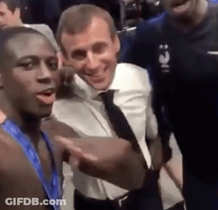A Group Of Men Are Standing Next To Each Other And Smiling . GIF