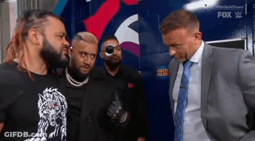 A Group Of Men Are Standing Next To Each Other And Talking . GIF