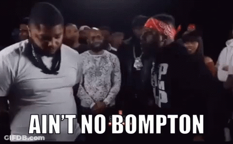 A Group Of Men Are Standing Next To Each Other In A Crowd And One Of Them Is Wearing A Bandana . GIF