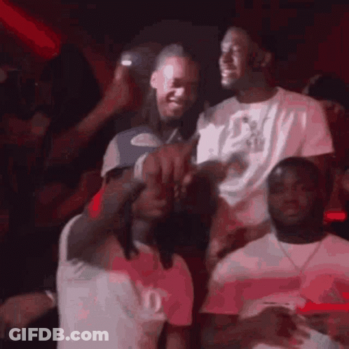 A Group Of Men Are Standing Next To Each Other In A Crowd At A Party . GIF
