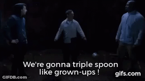 A Group Of Men Are Standing Next To Each Other In A Dark Room And Talking About Triple Spoon Like Grown-Ups . GIF