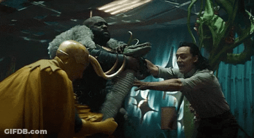 A Group Of Men Are Standing Next To Each Other In A Dark Room Holding Hands . GIF