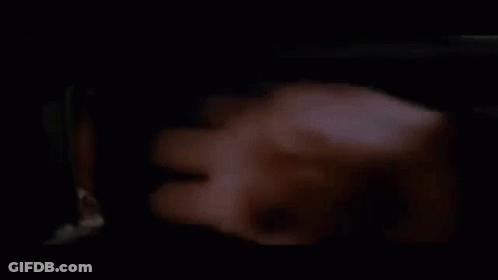A Group Of Men Are Standing Next To Each Other In A Dark Room Looking Through A Window . GIF