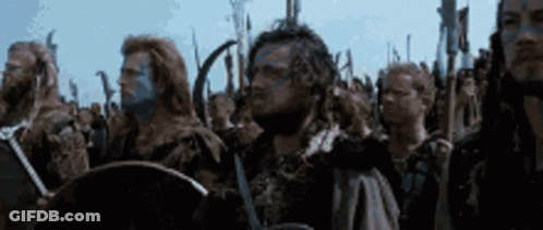 Men Standing In Line With Swords And Shields GIF