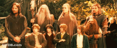 A Group Of Men Are Standing Next To Each Other In A Line . GIF
