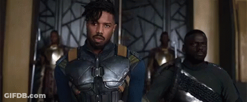 A Group Of Men Are Standing Next To Each Other In A Room And Looking At The Camera . GIF