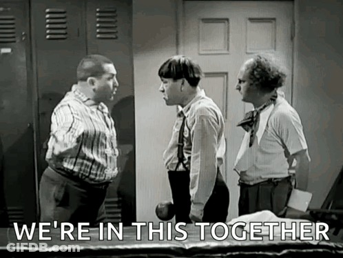 A Group Of Men Are Standing Next To Each Other In A Room And Talking . GIF
