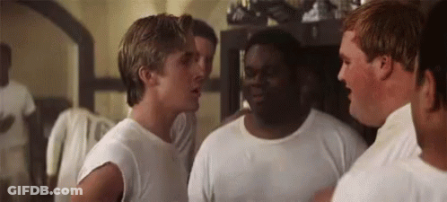 A Group Of Men Are Standing Next To Each Other In A Room And Talking . GIF