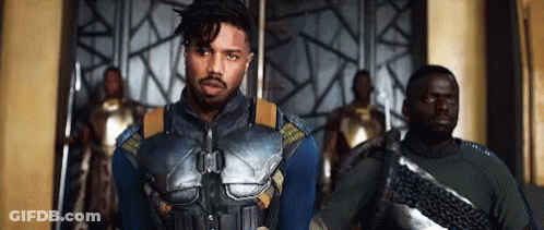 A Group Of Men Are Standing Next To Each Other In A Room . GIF