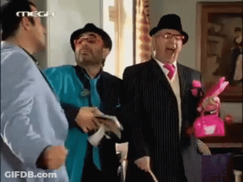 A Group Of Men Are Standing Next To Each Other In A Room With Mega Written On The Bottom Of The Screen GIF