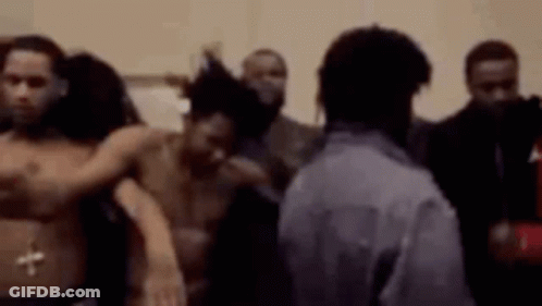 A Group Of Men Are Standing Next To Each Other In A Room Without Shirts On . GIF