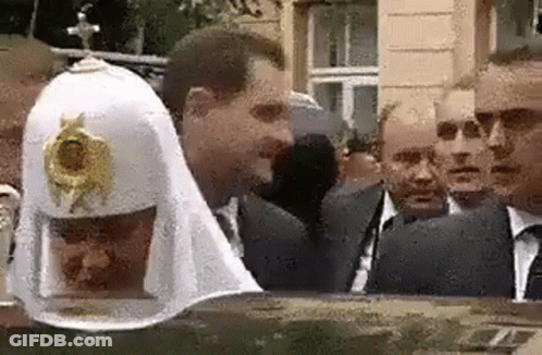 A Group Of Men Are Standing Next To Each Other In Front Of A Building . GIF