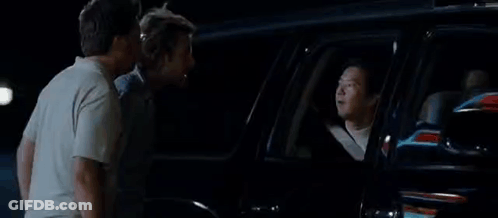 A Group Of Men Are Standing Next To Each Other In Front Of A Car With The Word Toodaloo On The Bottom . GIF