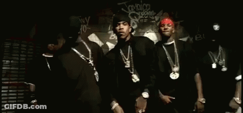 A Group Of Men Are Standing Next To Each Other In Front Of A Graffiti Wall . GIF