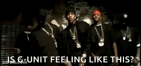 A Group Of Men Are Standing Next To Each Other In Front Of A Wall With Graffiti On It . GIF