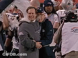 A Group Of Men Are Standing Next To Each Other On A Field . GIF