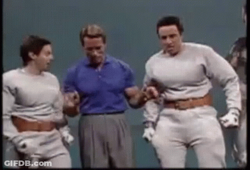 A Group Of Men Are Standing Next To Each Other On A Stage And Dancing . GIF
