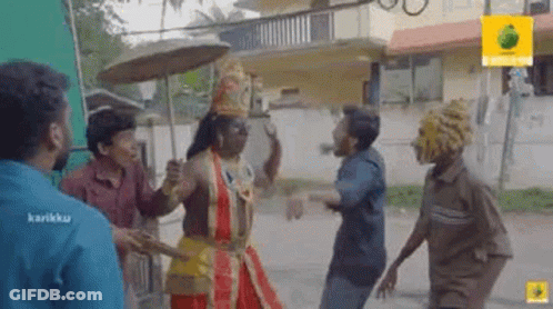 A Group Of Men Are Standing Next To Each Other On A Street . GIF