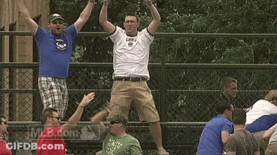 A Group Of Men Are Standing On A Fence With Their Arms In The Air GIF