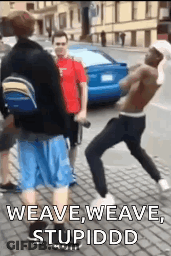 A Group Of Men Are Standing On A Sidewalk And One Of Them Says Weave Weave Stupiddd . GIF