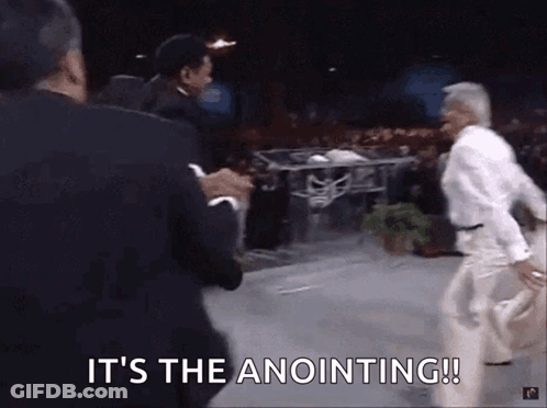 A Group Of Men Are Standing On A Stage With The Words It 'S The Anointing ! GIF