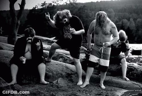 A Group Of Men Are Standing On Rocks And One Of Them Is Wearing A Shirt That Says ' King ' On It GIF