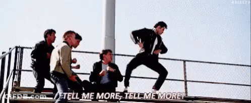 A Group Of Men Are Standing On Top Of A Staircase . GIF