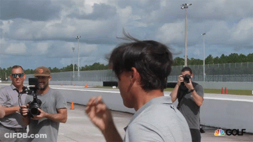 A Group Of Men Are Taking Pictures Of A Man With The Nbc Golf Logo In The Corner GIF