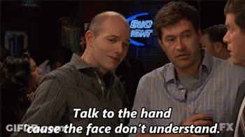 A Group Of Men Are Talking To Each Other In A Bar . GIF