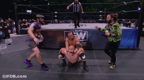A Group Of Men Are Wrestling In A Ring With A Sign That Says Elite Wrestling GIF