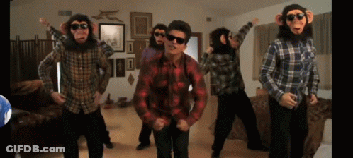 A Group Of Men Dressed As Monkeys Are Dancing In A Living Room GIF