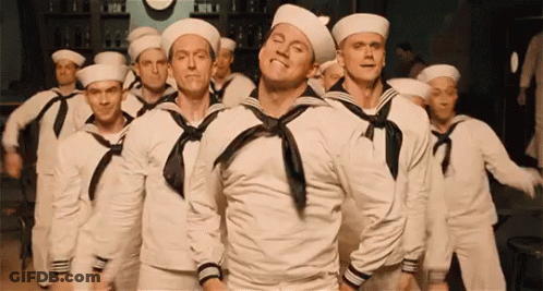 A Group Of Men Dressed As Sailors Are Dancing In A Room . GIF