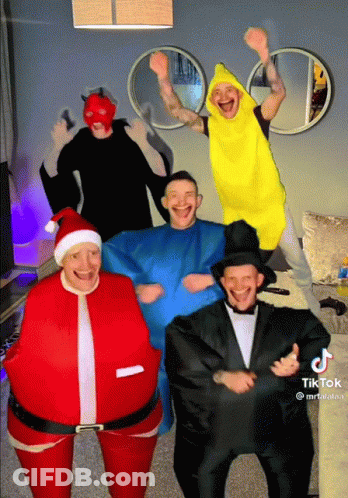 A Group Of Men Dressed In Costumes Including Santa And Banana GIF