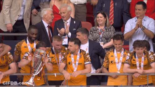 A Group Of Men Holding A Trophy With The Number 10 On Their Jersey GIF