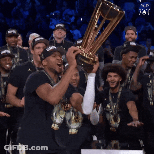 A Group Of Men Holding A Trophy With The Word Champions On It GIF