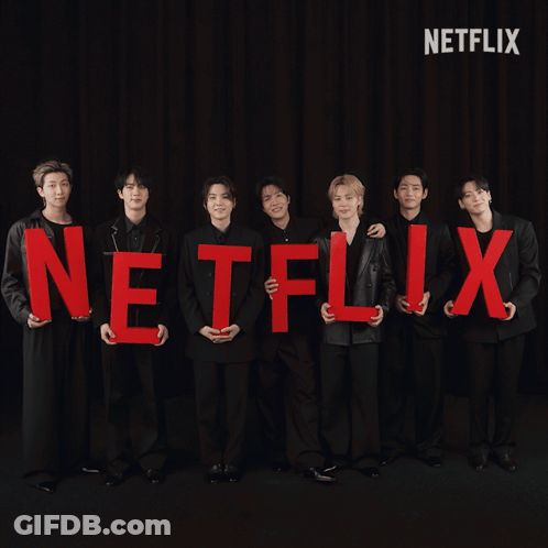 A Group Of Men Holding Red Letters That Spell Out The Word Netflix GIF