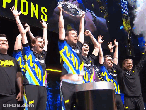 A Group Of Men Holding Up A Trophy That Says ' Champions ' On It GIF