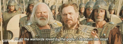 A Group Of Men In Armor Are Standing Next To Each Other And One Of Them Is Talking About The Warlords Loved By The Gods GIF