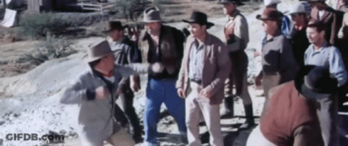 A Group Of Men In Cowboy Hats Are Standing Next To Each Other In A Field . GIF