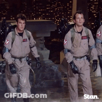 A Group Of Men In Ghostbusters Uniforms Walking GIF