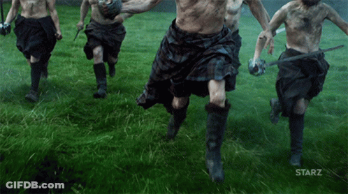 A Group Of Men In Kilts Are Running Through A Grassy Field With The Starz Logo In The Corner GIF