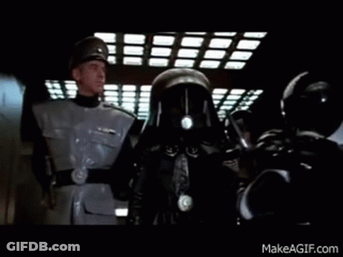 A Group Of Men In Military Uniforms Are Standing Next To Each Other In A Dark Room . GIF
