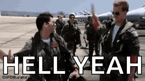 A Group Of Men In Military Uniforms Are Standing On A Runway With The Words Hell Yeah Written In White GIF