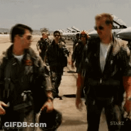 A Group Of Men In Military Uniforms Are Walking On A Runway .. GIF