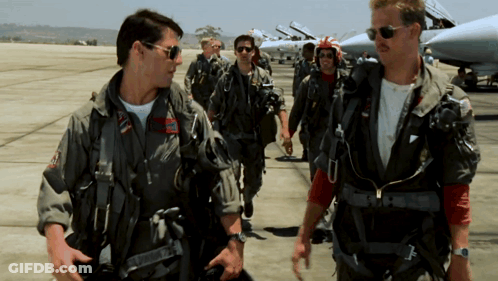A Group Of Men In Military Uniforms Are Walking On A Tarmac GIF