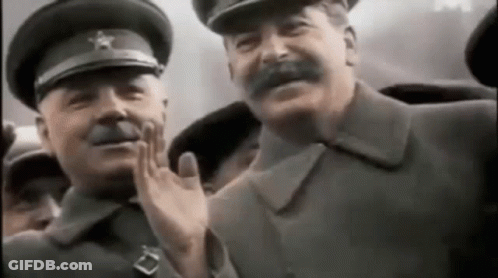 A Group Of Men In Military Uniforms Are Waving At Each Other In A Crowd . GIF