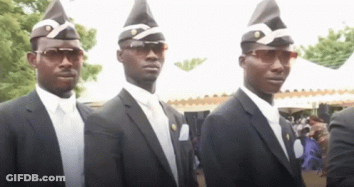 A Group Of Men In Suits And Hats Are Standing In A Line . GIF
