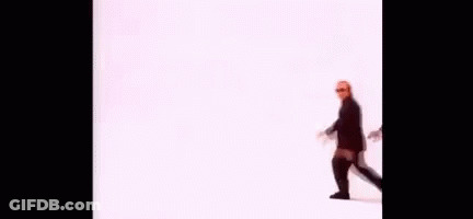 A Group Of Men In Suits And Sunglasses Are Walking In A Line On A White Background . GIF