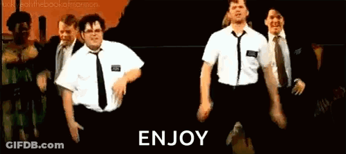 A Group Of Men In Suits And Ties Are Dancing On A Stage In Front Of A Sign That Says `` Enjoy '' . GIF