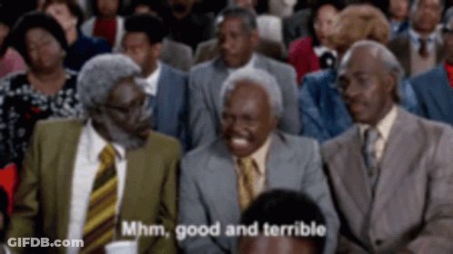 A Group Of Men In Suits And Ties Are Sitting In A Crowd And One Of Them Is Laughing And Saying Mhm Good And Terrible GIF